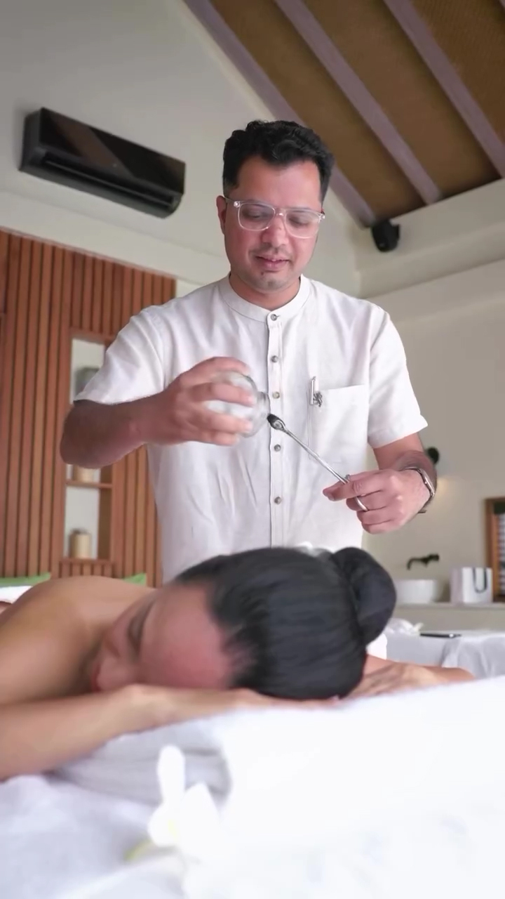 Dr Sohal performing a facial massage treatment.