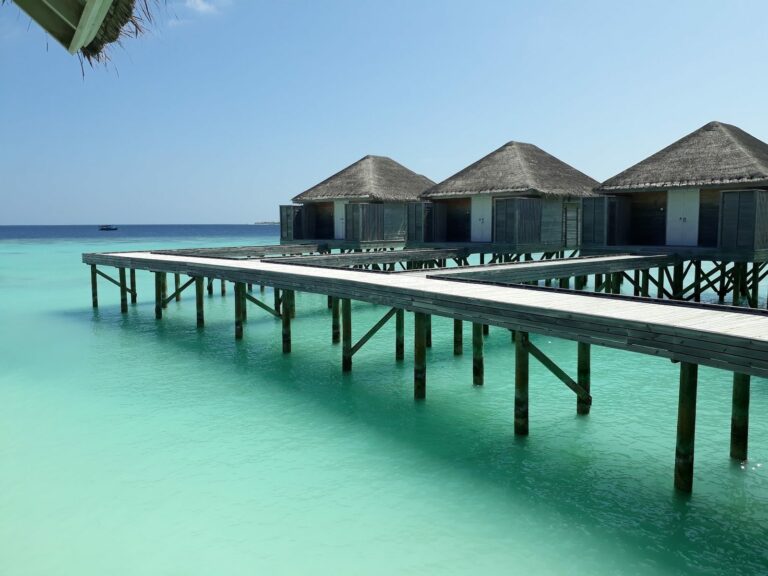 Overwater villas and timber jetty above a turquoise lagoon in the Maldives
