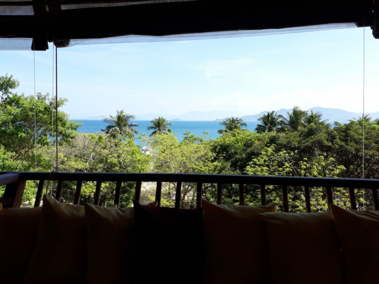 View from a resort villa balcony over palms to the sea, Vietnam