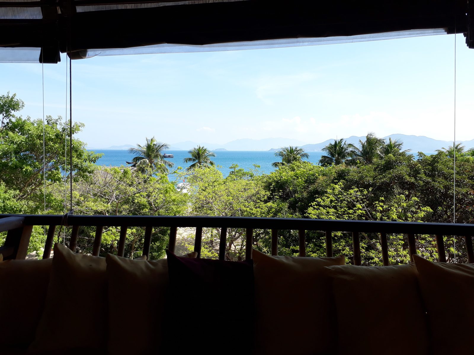 View from a resort villa balcony over palms to the sea, Vietnam