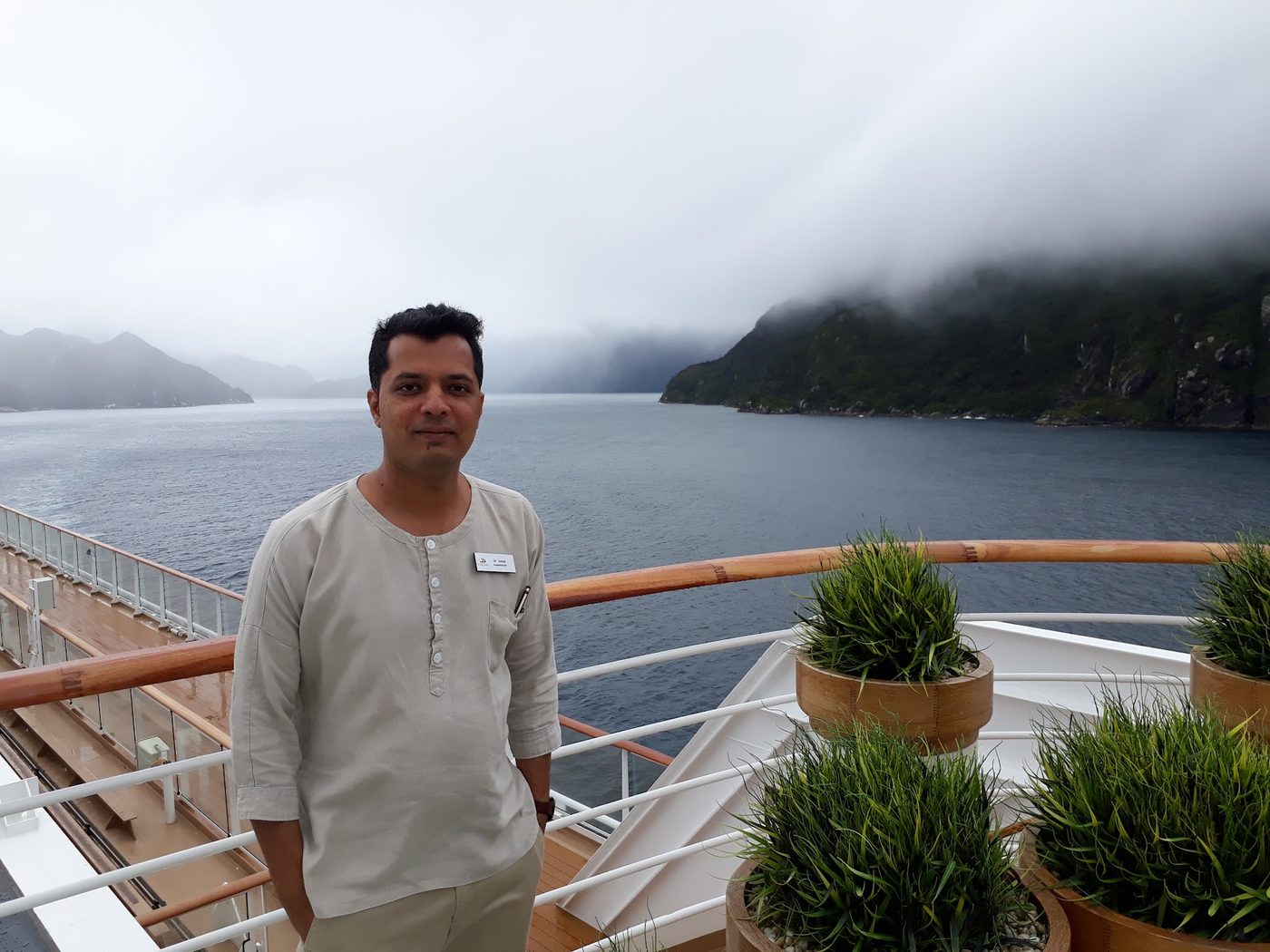 Sohal Shah on the deck of a Viking Ocean ship in a fjord